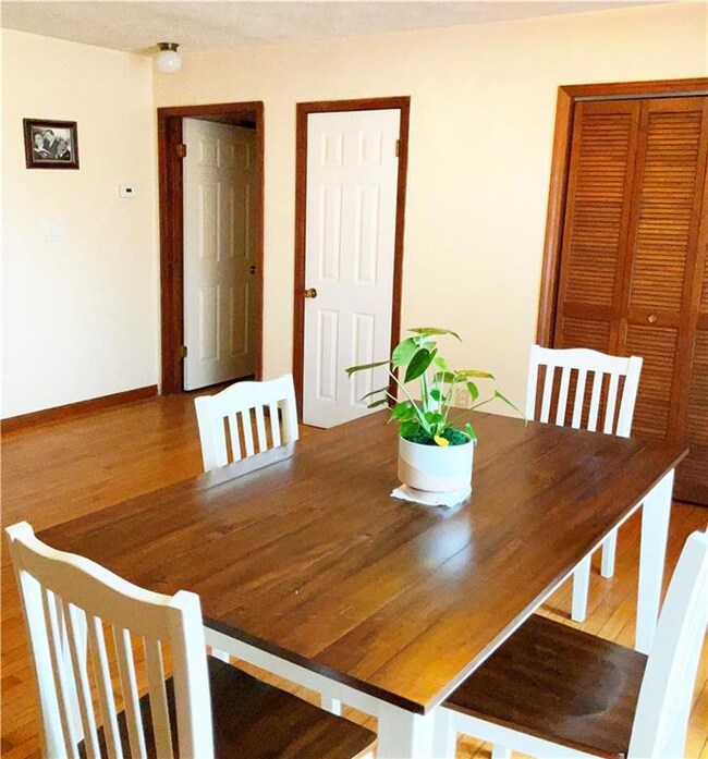 Unfurnished dining area featuring wood-type floori