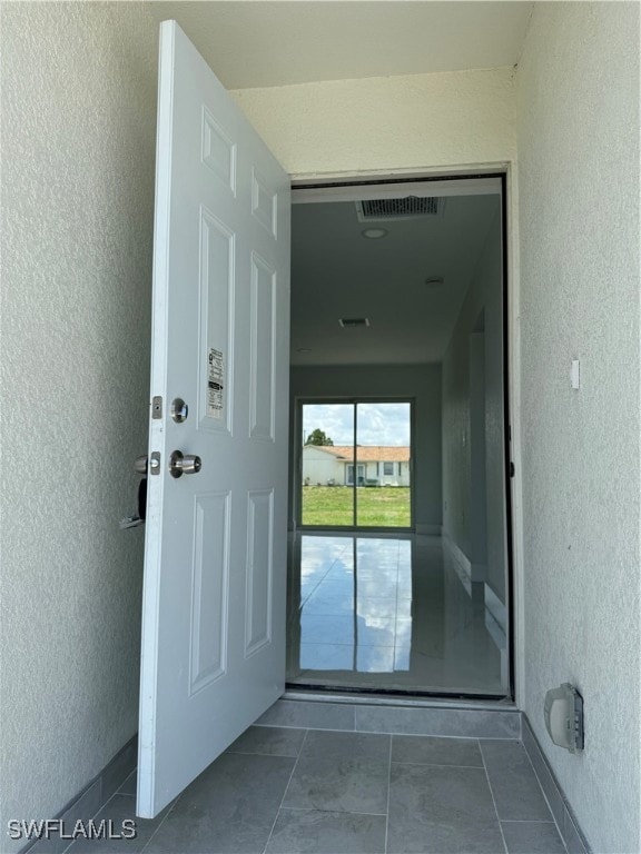 View of exterior entry featuring stucco siding
