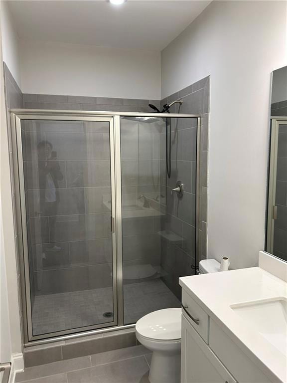 Bathroom featuring a shower stall, tile patterned 