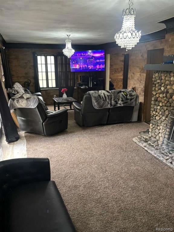 Living area featuring a chandelier, wood walls, and carpet