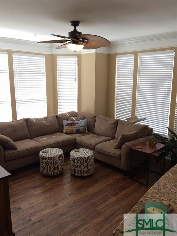 Large living room with bay windows, wide crown mol