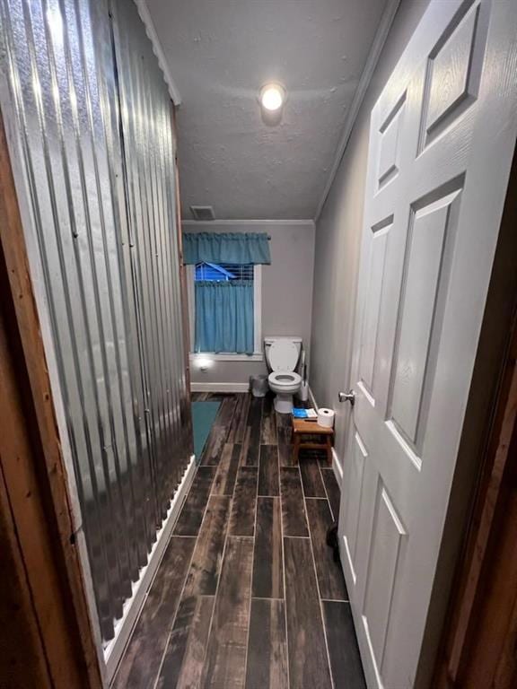 Hallway featuring crown molding and dark wood-type