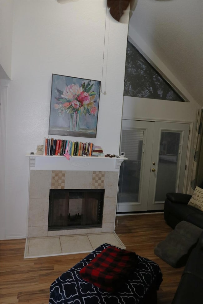 Living room with vaulted ceiling, a fireplace, fre
