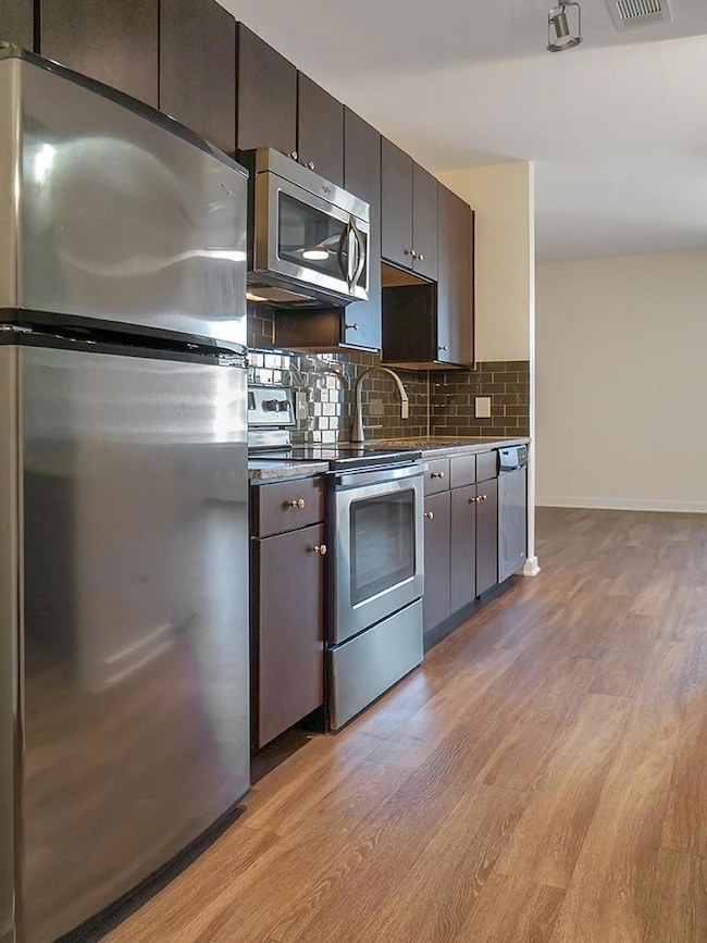 Kitchen featuring stainless steel appliances, lig
