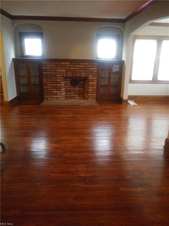 Open living room overlooks the enclosed porch (which makes a great sitting room).  Leaded glass bookshelves add to the charm.