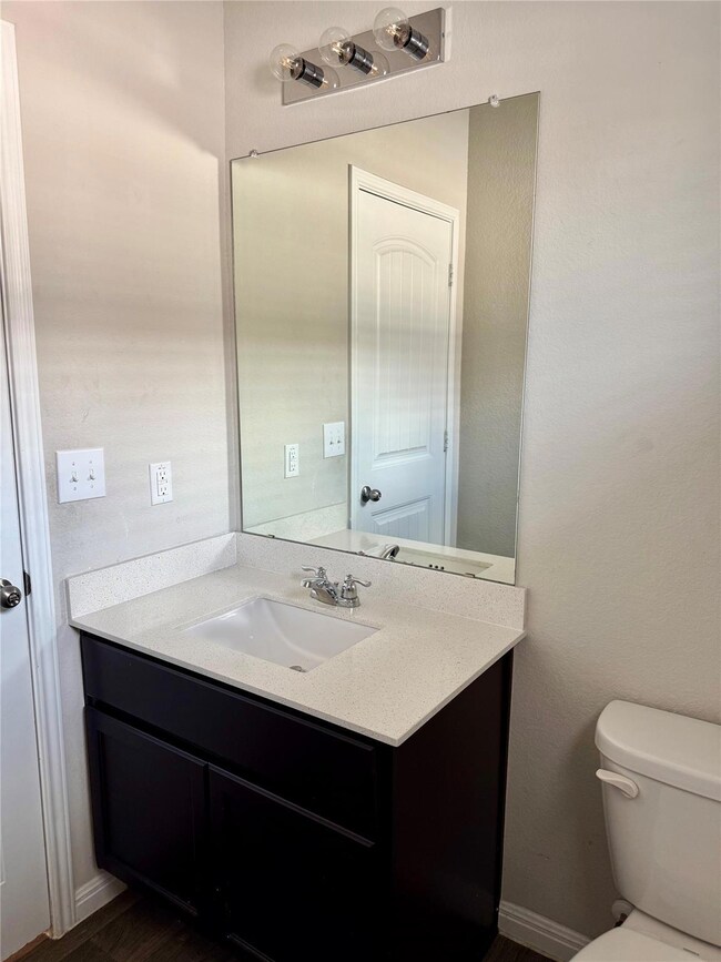 Bathroom featuring vanity and wood finished floors