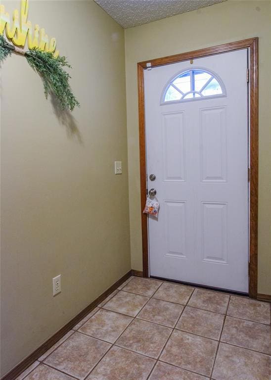 Tiled entrance foyer with a textured ceiling