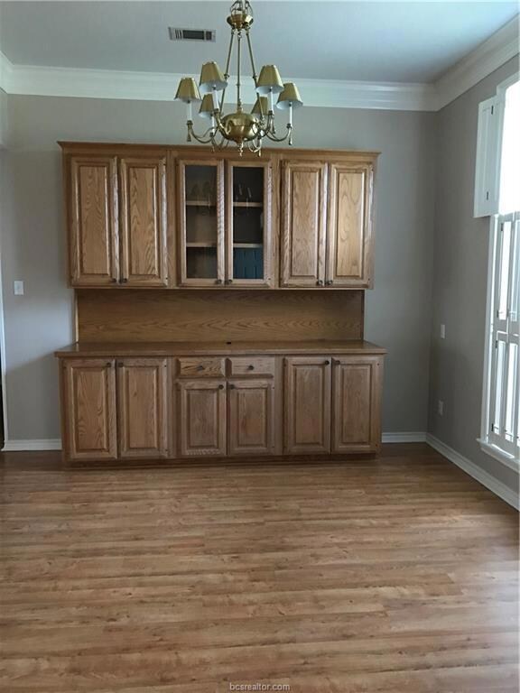 Unfurnished dining area with a chandelier, light w