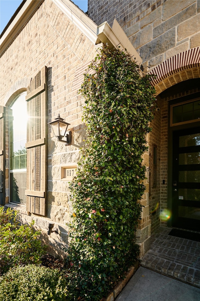 This home features a welcoming entrance, with lush