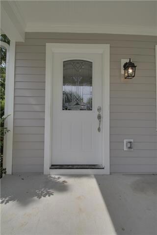 Charming details include beveled glass front door