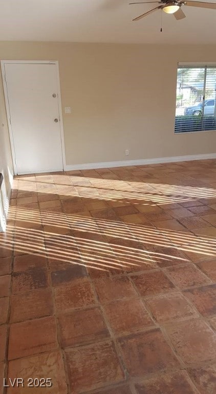 Empty room with baseboards and ceiling fan