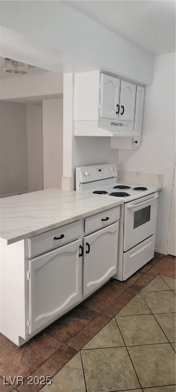 Kitchen with range, white cabinetry, light stone c