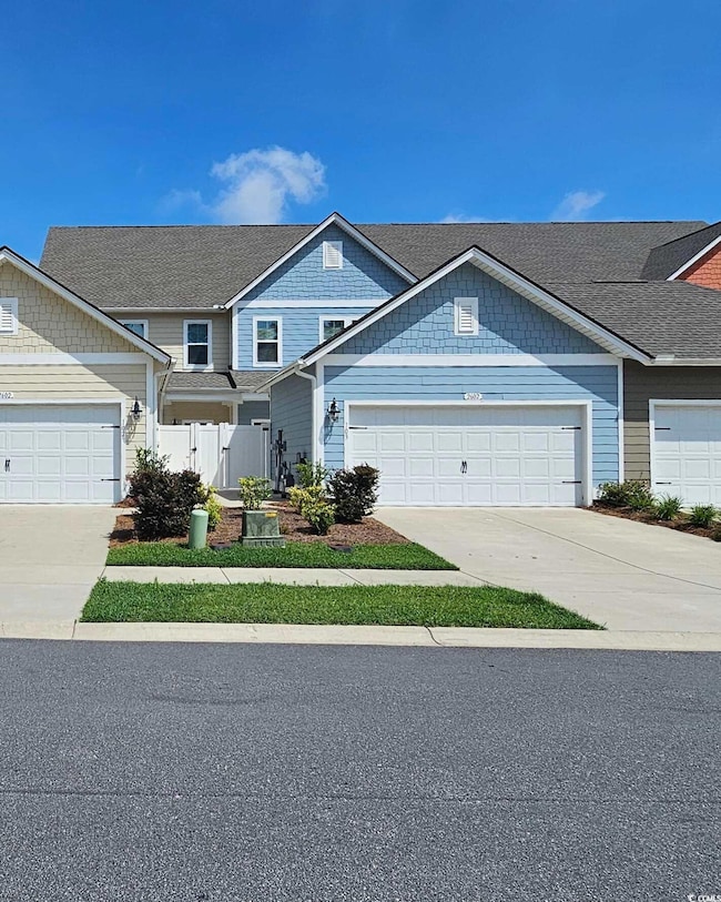 View of front of home featuring driveway and an attached garage