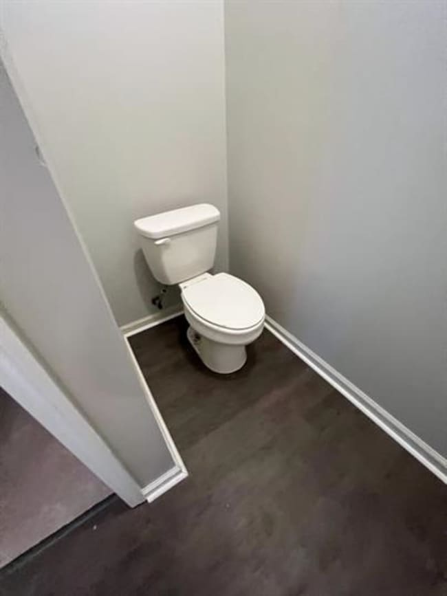 Bathroom with toilet and baseboards