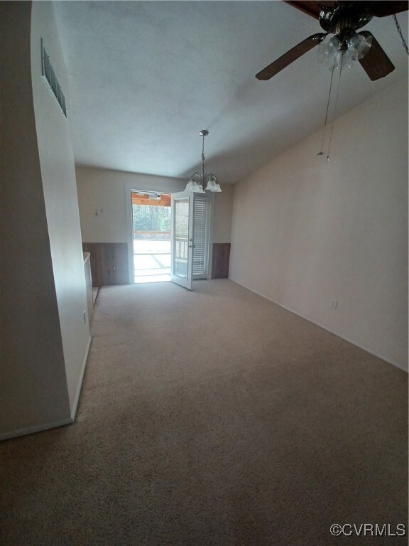Unfurnished living room featuring ceiling fan with
