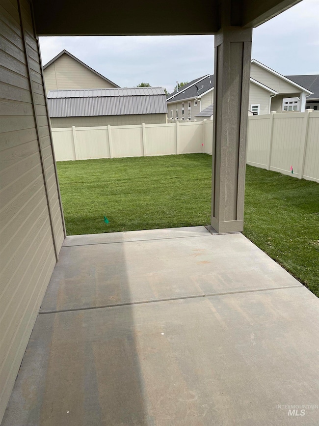 Fenced backyard with a patio area
