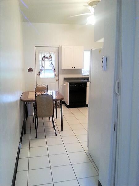 Updated kitchen with tile floors and white cabinet