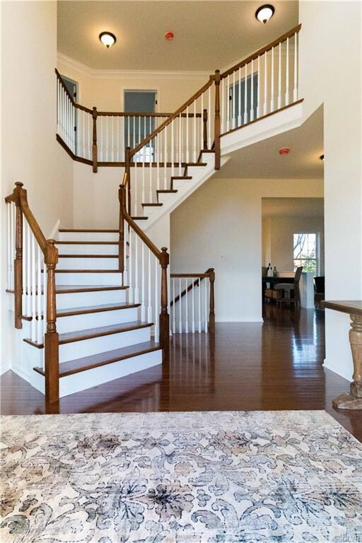 Stunning 2 story foyer with dual turned staircase 