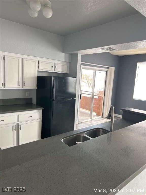 Kitchen featuring freestanding refrigerator, white