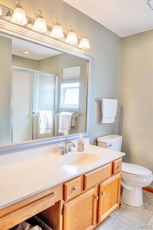 Full bathroom with vanity, a stall shower, and light tile patterned flooring