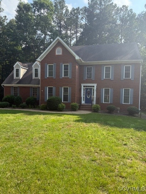 View of front of home featuring brick siding and a