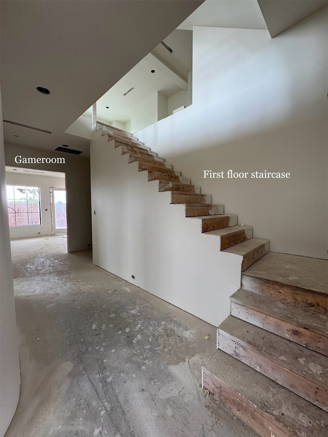 THREE-STORY entry. Photo of the first floor, opening up to the game room.