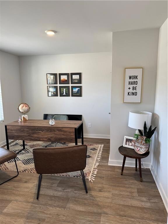 Office space featuring baseboards and wood finishe