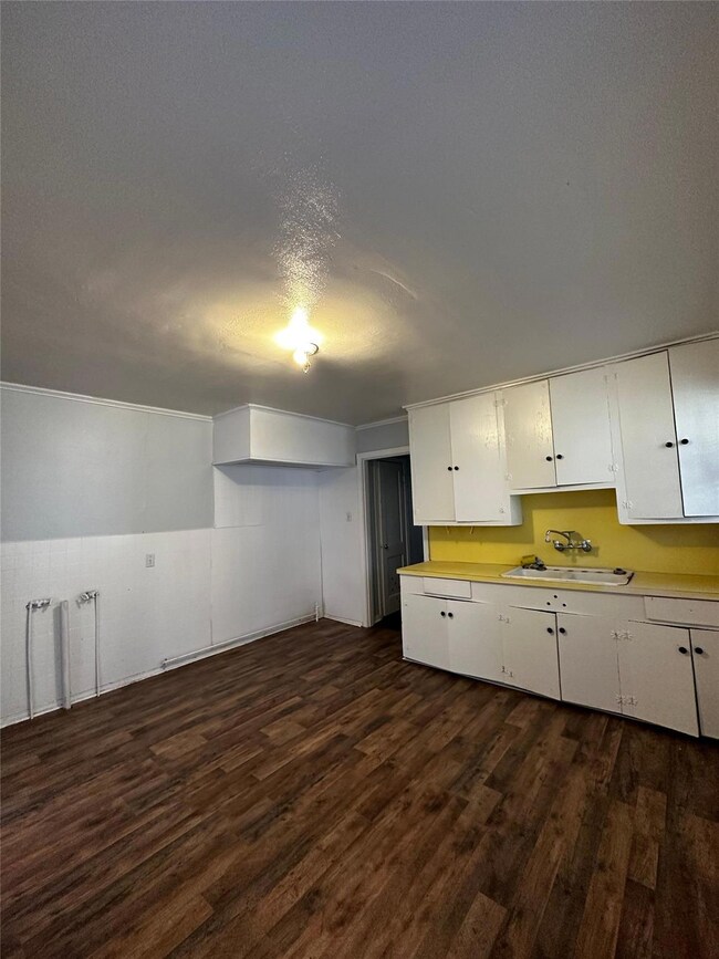 Kitchen with a textured ceiling, dark hardwood / w