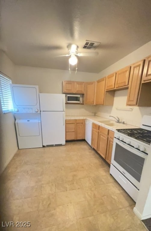 Kitchen with white appliances, estacked washer and