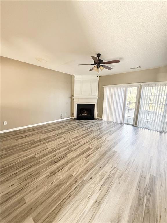 Unfurnished living room with a large fireplace, ba