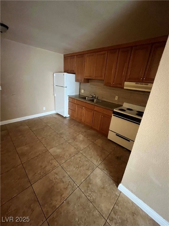 Kitchen with white appliances, a sink, under cabin