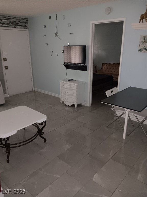 Playroom with baseboards and marble finish floor