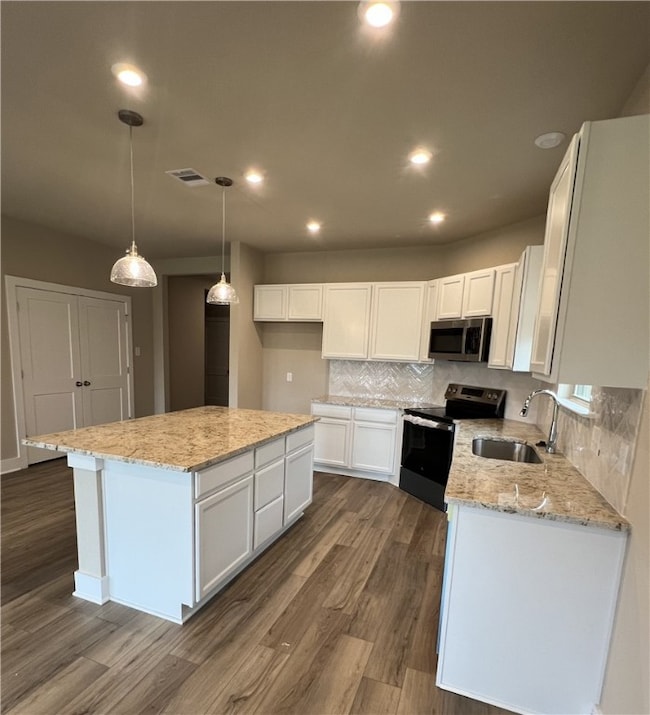 Kitchen with stainless steel appliances, white cab