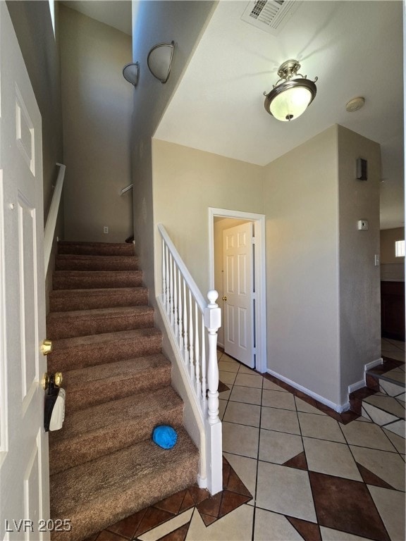 Stairs featuring tile patterned flooring