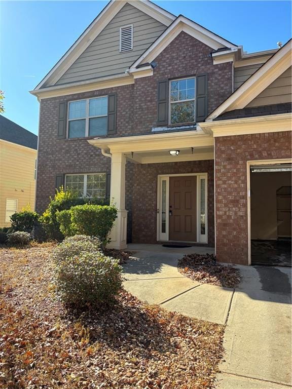 Craftsman inspired home with a porch and brick siding