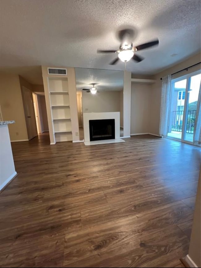 This spacious living area features wood flooring,