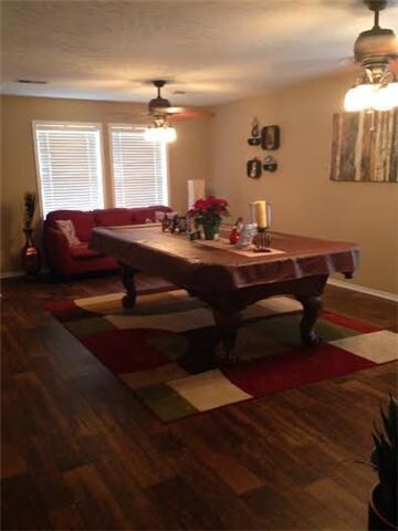 living dining area. double ceiling fans and great moldings on windows.  lots of natural light