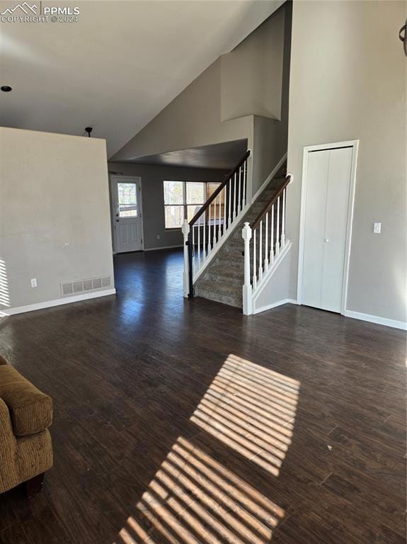 Unfurnished living room featuring dark hardwood / 