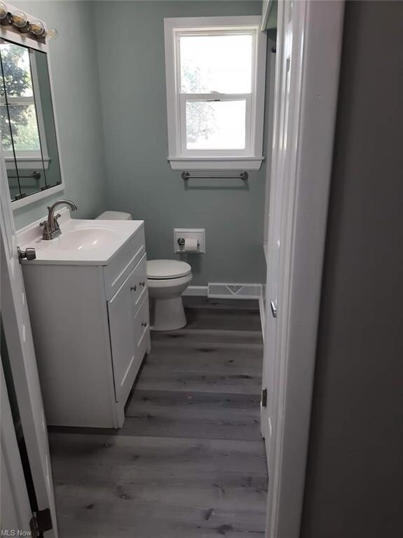 Bathroom with dark hardwood floors, oversized vani