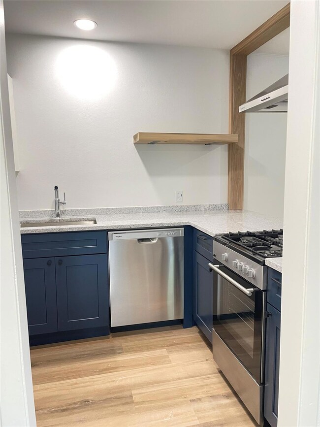 Kitchen featuring stainless steel appliances, a s