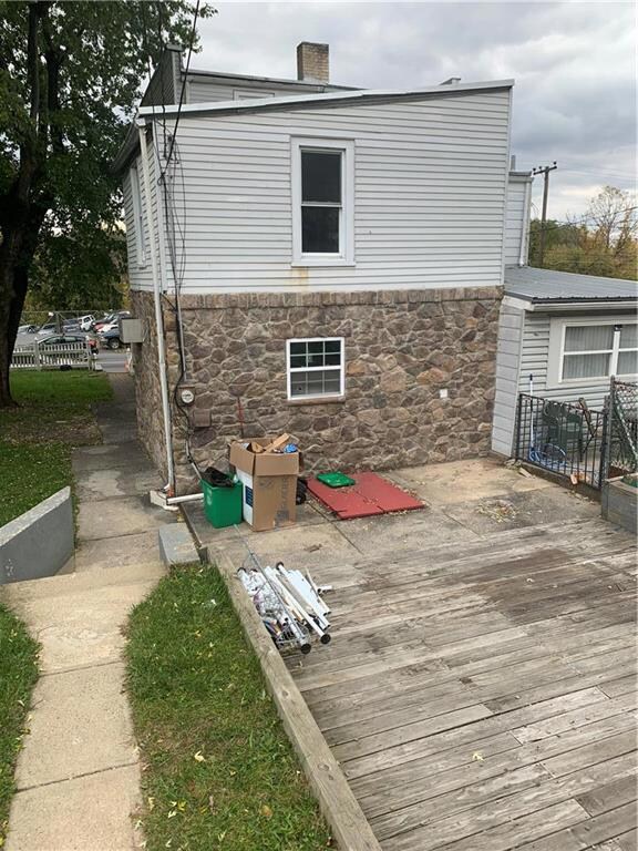 Rear of home w/ large wooden deck