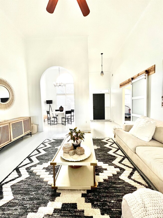 Living room featuring ceiling fan with notable cha