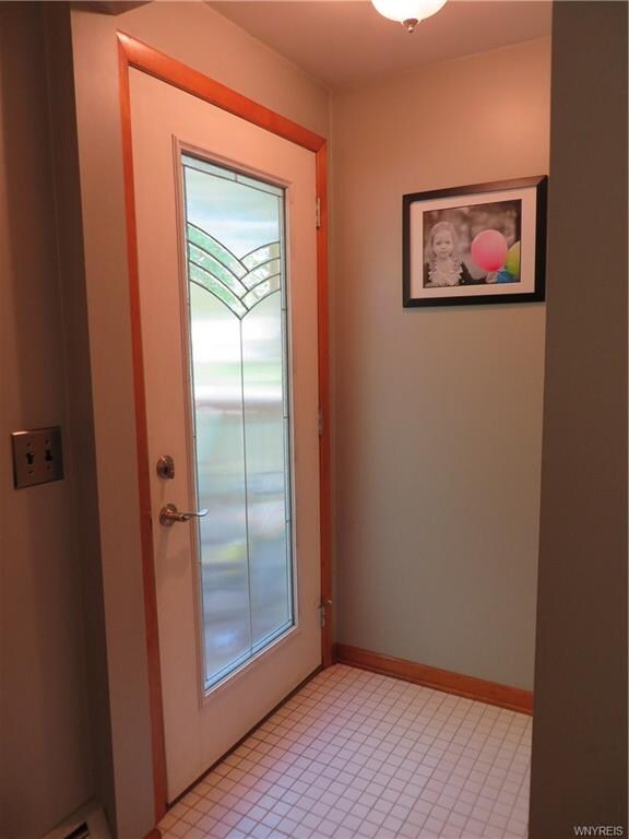 Updated foyer with new ceramic tile flooring.