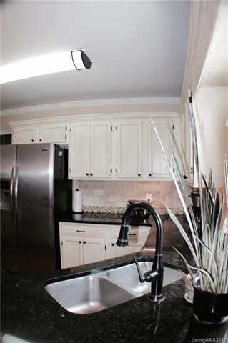Beautiful back-splash, double sinks and white cabi