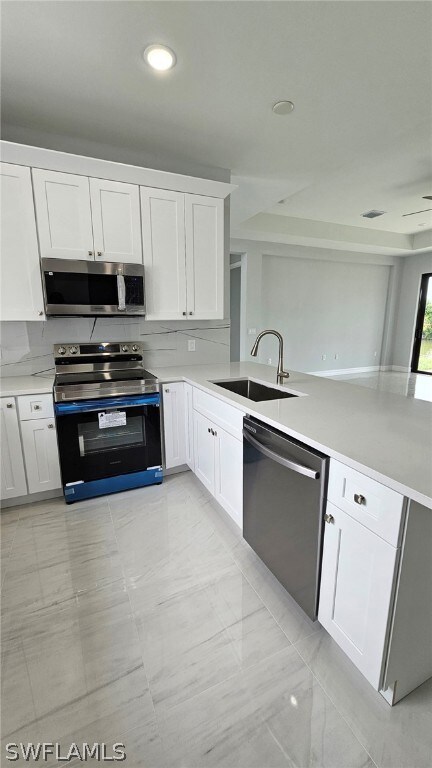 Kitchen with tasteful backsplash, light tile floor