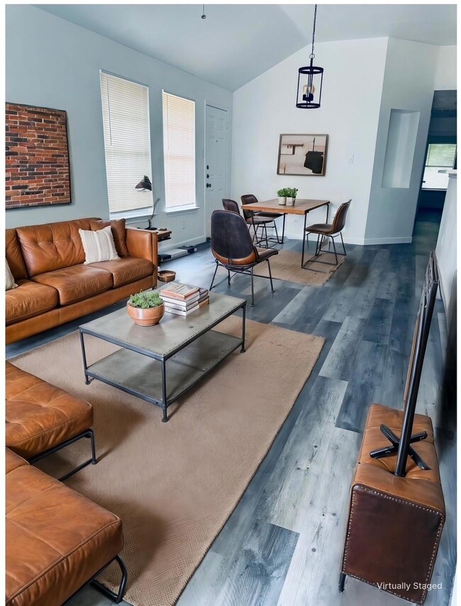 Living area with baseboards, wood finished floors