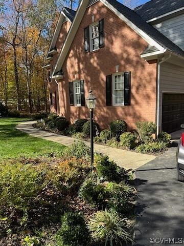 View of side of property featuring a garage