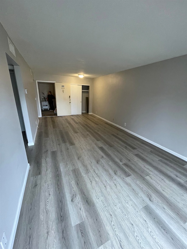 Unfurnished living room with wood-type flooring