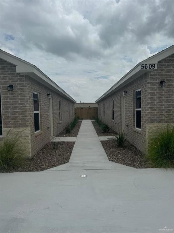 View of side of home featuring brick siding