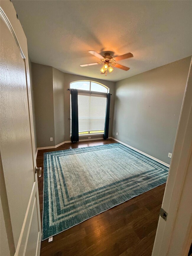 Spare room featuring a ceiling fan, wood finished